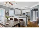 Eat-in kitchen with white cabinets, stainless appliances, and hardwood floors at 484 Martin Se St, Atlanta, GA 30312