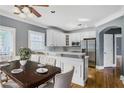 Bright kitchen area boasts white cabinetry, stainless steel appliances, and a breakfast bar with seating at 484 Martin Se St, Atlanta, GA 30312