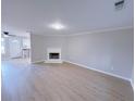 Spacious living room featuring a fireplace, light-colored walls, and wood-look flooring at 6716 Browns Mill Ferry Dr, Lithonia, GA 30038