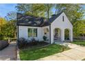 Charming white brick home featuring a covered arched porch and well-manicured lawn at 1184 Metropolitan Sw Pkwy, Atlanta, GA 30310