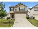 Charming two-story home with a brick-accented front, attached garage, and a well-maintained lawn at 6119 Hickory Lane Dr, Union City, GA 30291
