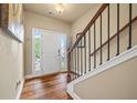 Inviting foyer with hardwood floors, a staircase, and a bright white front door with sidelights at 6119 Hickory Lane Dr, Union City, GA 30291
