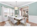 Bright dining room featuring a marble-top table, elegant chairs, and large windows at 4273 Creekrun Cir, Buford, GA 30519