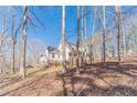 Picturesque two-story home nestled among trees and lush greenery in a serene setting at 170 River Cove Rdg, Social Circle, GA 30025