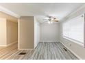 Living room featuring gray floors, neutral paint, large window, and modern ceiling fan at 6202 Humphries Hill Rd, Austell, GA 30106