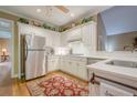 Bright kitchen with white cabinets, stainless steel appliances, and hardwood floors at 6360 Brookline Ct, Cumming, GA 30040