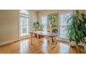 Bright office space with hardwood floors, large windows, and ample natural light, ideal for a home workspace at 6360 Brookline Ct, Cumming, GA 30040