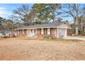 Cozy brick home with an attached garage and a well-kept lawn at 999 Chestnut Oak Ct, Lawrenceville, GA 30046