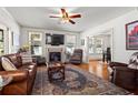 Comfortable living room with fireplace, hardwood floors, and large windows for natural light at 2653 Brookwood Ne Dr, Atlanta, GA 30305