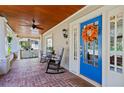 Inviting front porch with brick flooring, rocking chairs, and a bright blue front door at 2653 Brookwood Ne Dr, Atlanta, GA 30305