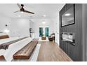 Relaxing main bedroom boasts fireplace feature, chandelier lighting, sitting area, and private balcony at 3882 The Ascent Ne, Brookhaven, GA 30319