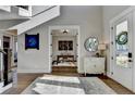 Open foyer with hardwood floors and a view to the home office through french doors at 3820 Reserve Overlook Way, Cumming, GA 30041