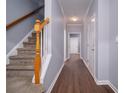 Inviting hallway featuring hardwood floors, neutral paint, and a staircase at 5381 Briar Creek Ln, Norcross, GA 30071