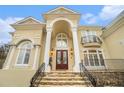 Close up of a grand entrance with stone steps leading to a double door entry and a balcony at 4040 Annecy Dr, Atlanta, GA 30331