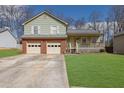 Charming two-story home with a well-maintained lawn, a two-car garage, and inviting front porch at 618 Jenmarie Sw Dr, Mableton, GA 30126