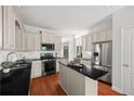 Modern kitchen with stainless steel appliances, granite countertops, white cabinets and hardwood floors at 2742 Oak Village Trl, Decatur, GA 30032
