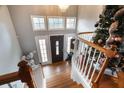 Grand foyer featuring hardwood floors, staircase, and an elegant chandelier above the front door at 4558 Bronte Ln, Douglasville, GA 30135