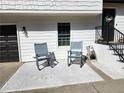 Cozy front porch with two blue rocking chairs, perfect for enjoying the outdoors at 11250 Bramshill Dr, Johns Creek, GA 30022