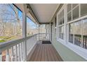 Inviting covered porch with views of lush greenery and a quiet street at 2401 Westland Way, Acworth, GA 30102