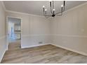 Bright dining room featuring stylish chandelier and wood flooring at 260 N Fayette Dr, Fayetteville, GA 30214