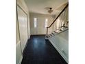 Open entryway featuring a staircase and slate flooring leading to the front door at 4617 N Peachtree Rd, Dunwoody, GA 30338