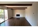 Bright living room with hardwood floors, white brick fireplace and sliding glass door at 4617 N Peachtree Rd, Dunwoody, GA 30338