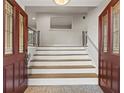A welcoming entryway with a staircase featuring a unique patterned floor and glass paneled front door at 2153 Starfire Drive Ne Dr, Atlanta, GA 30345