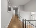 Bright hallway with hardwood floors and modern railing overlooking the front entry and stairs at 2153 Starfire Drive Ne Dr, Atlanta, GA 30345