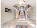 Spacious foyer with a winding staircase, elegant lighting, and travertine flooring at 3017 Canton Pines, Marietta, GA 30068
