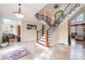 Beautiful foyer featuring travertine flooring, a winding staircase, and sunlit windows at 3017 Canton Pines, Marietta, GA 30068
