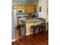 Galley kitchen with granite countertops, updated appliances, and breakfast bar seating at 1349 Orchard Park Dr, Stone Mountain, GA 30083