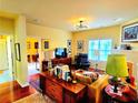 Comfortable living room with bright yellow walls, hardwood floors, and stylish decor at 1349 Orchard Park Dr, Stone Mountain, GA 30083