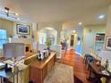 Open concept living room featuring hardwood floors, a decorative fireplace, and elegant furnishings at 1349 Orchard Park Dr, Stone Mountain, GA 30083