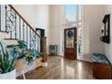 Bright foyer featuring hardwood floors, staircase with ornate iron railing, high ceilings and large windows at 1701 Crowes Lake Ct, Lawrenceville, GA 30043