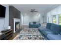 Living room featuring a decorative fireplace, plush sofas, and natural lighting at 2702 Wedgewood Ter, Decatur, GA 30032