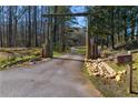 Rustic wooden archway welcomes you to the property with a long, paved driveway at 3721 Mason Creek Rd, Winston, GA 30187