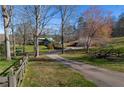 Quaint home with a green roof, partially obscured by trees, with a fenced yard at 3721 Mason Creek Rd, Winston, GA 30187
