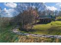 Scenic view of a log home nestled on a lush green lawn with mature trees at 3721 Mason Creek Rd, Winston, GA 30187