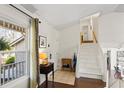 Welcoming foyer with hardwood floors, staircase, and natural light from a large window at 6038 Maryjo Ln, Norcross, GA 30093