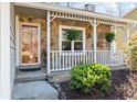 Inviting front porch with stone facade, white railings, and well-maintained landscaping at 6038 Maryjo Ln, Norcross, GA 30093