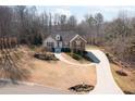 Charming single-story home featuring a manicured lawn, red shutters, and stone accents at 6935 Autumn Hills Dr, Cumming, GA 30028