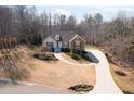 Inviting one-story home features beautiful landscaping and a curved driveway at 6935 Autumn Hills Dr, Cumming, GA 30028