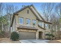 Charming home featuring stone accents, neutral siding, mature trees, and an attached two-car garage at 316 Silverwood Dr, Dallas, GA 30157