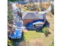 Aerial view of brick home showcasing the backyard, deck, and detached garage at 3970 Brenteresa Ct, Snellville, GA 30039