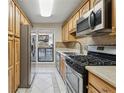 Galley kitchen featuring tile floors and stainless steel appliances at 408 River Run Dr, Atlanta, GA 30350