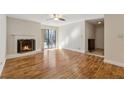 Bright living room featuring a fireplace, sliding glass doors, and hardwood flooring at 408 River Run Dr, Atlanta, GA 30350