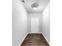 Entryway features hardwood floors and a white front door at 7104 Skippingstone Way, Douglasville, GA 30134