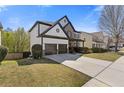 Inviting home exterior with a spacious driveway, attached two-car garage, and manicured lawn at 7382 Gossamer St, Union City, GA 30291