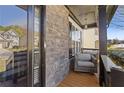 Cozy front porch with stone accents, featuring comfortable seating and a charming, welcoming ambiance at 7382 Gossamer St, Union City, GA 30291