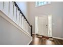 Bright foyer with elegant staircase, wood floors, and natural light streaming in at 2836 Springrock Way, Lawrenceville, GA 30043